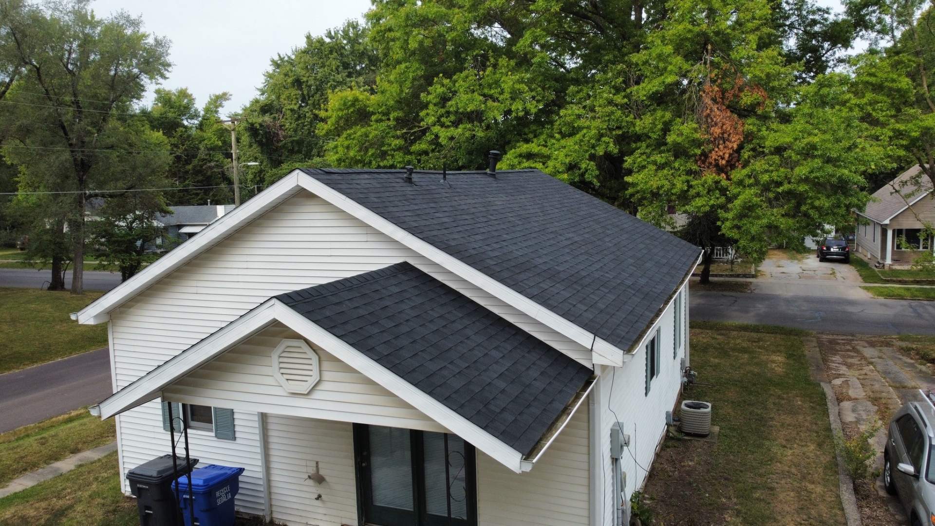 Completed residential roof — street-level drone view